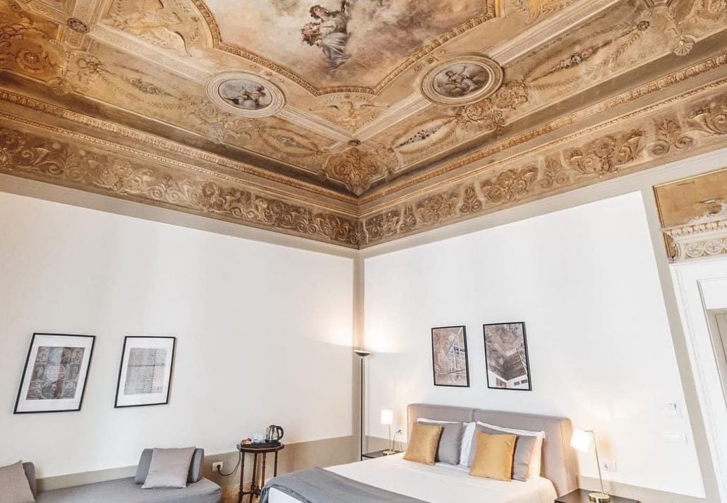 A suite with wooden details on the ceiling at Relais Della Porta, Naples, Italy 
