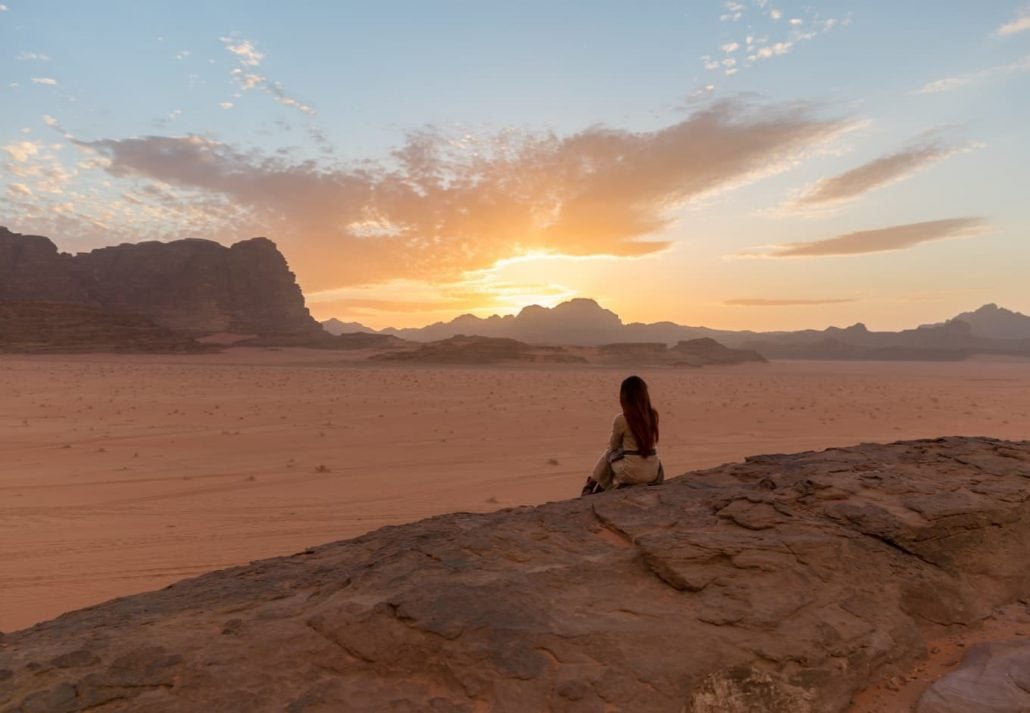 A girl watching the sunset in Wadi Rum