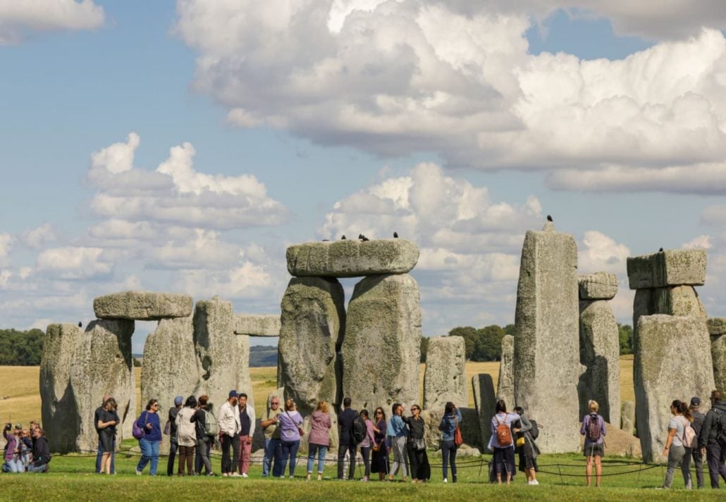 A group of tourists in front of Stonehenge