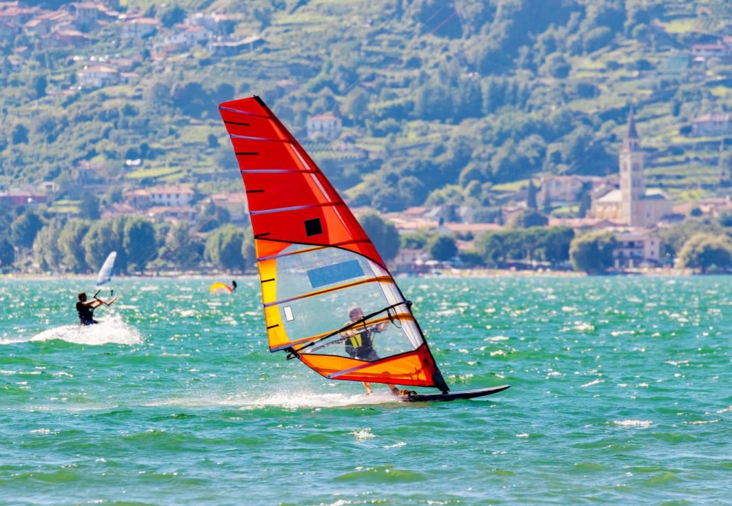 A male windsurfing on Lake Como