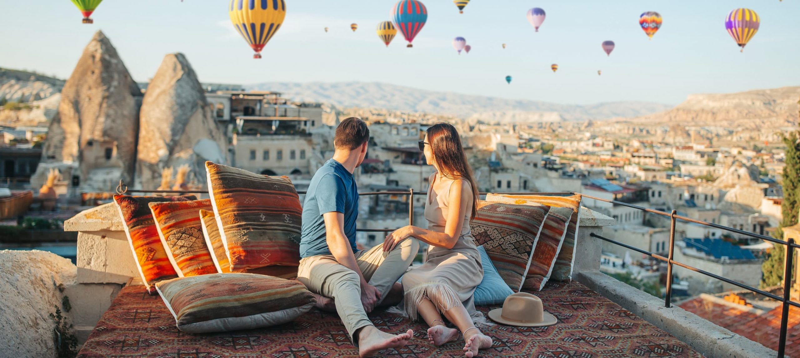 Couple watching the flight of hot air balloons in Cappadocia, Turkey.