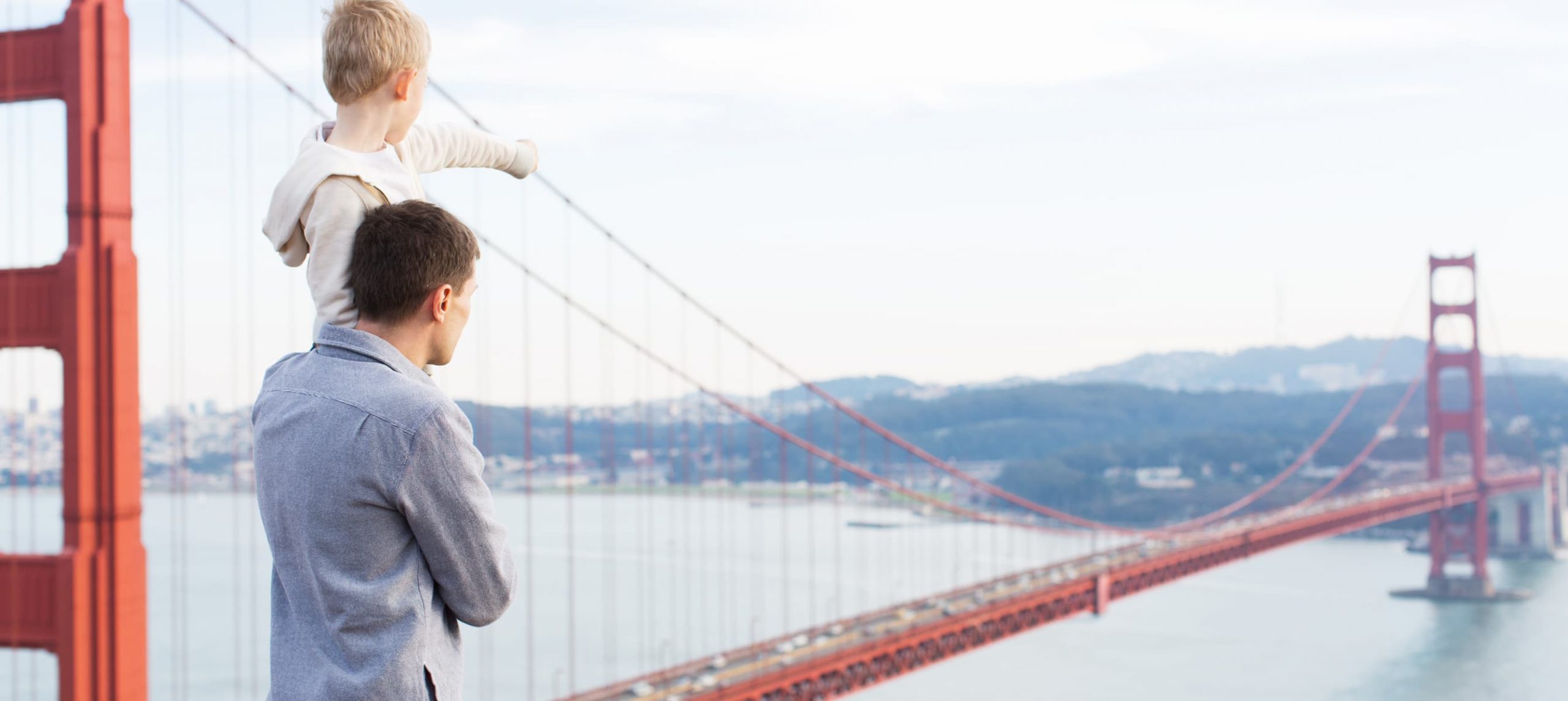 Father with his son marveling at the Golden Gate Bridge in San Francisco, California.