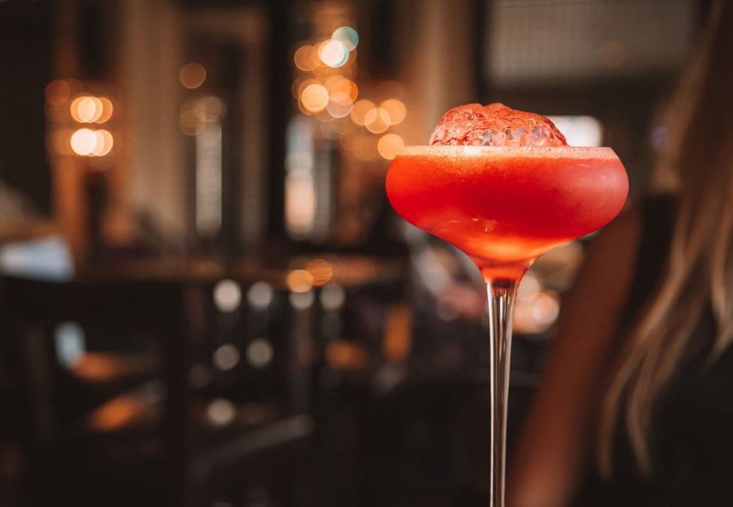 A pink cocktail on a table