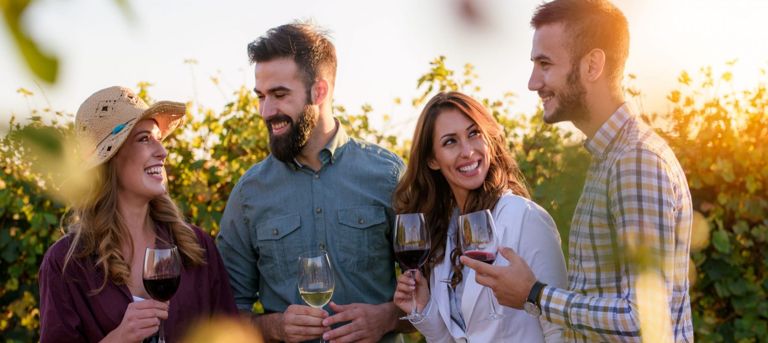 A group of people tasting wine