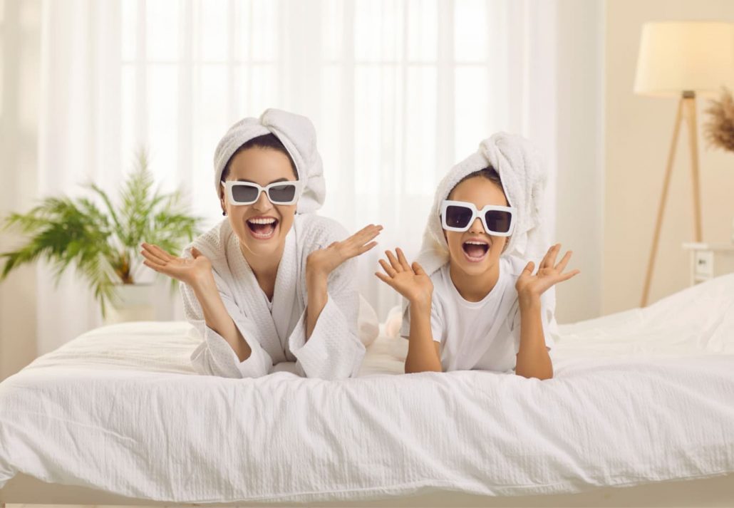 Mom and daughter wearing sunglasses and posing for the camera