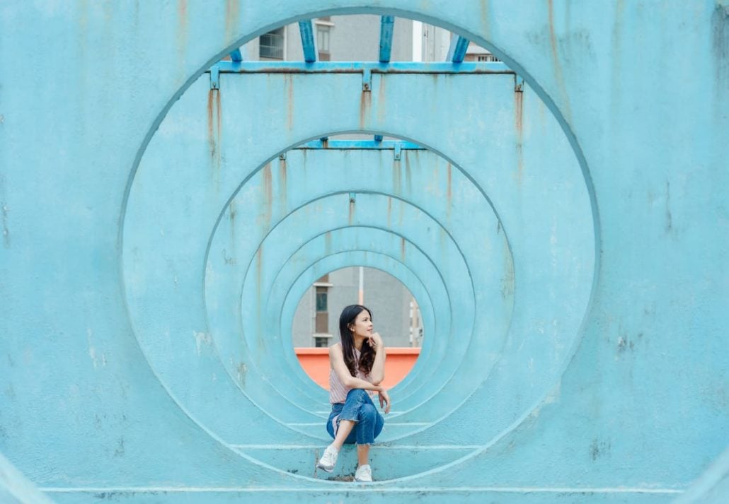 Young woman traveler visiting Lok Wah South Estate Circle Round spot for photography tourist