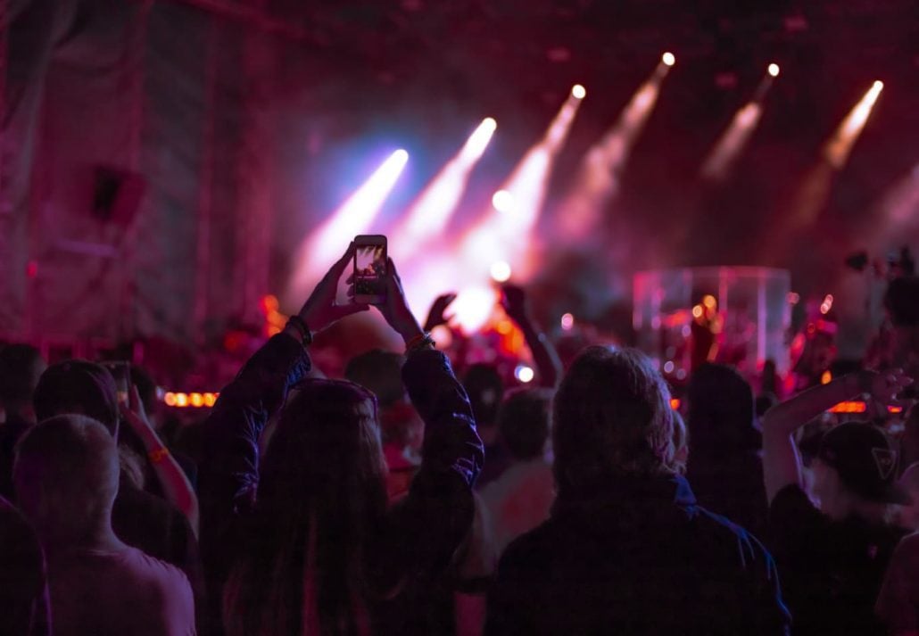 A group of people watching a live performance at a club