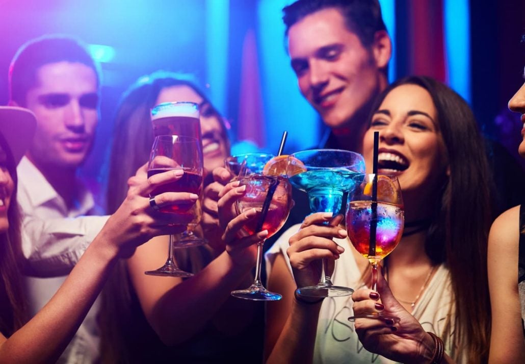 Friends smiling with drinks in their hands