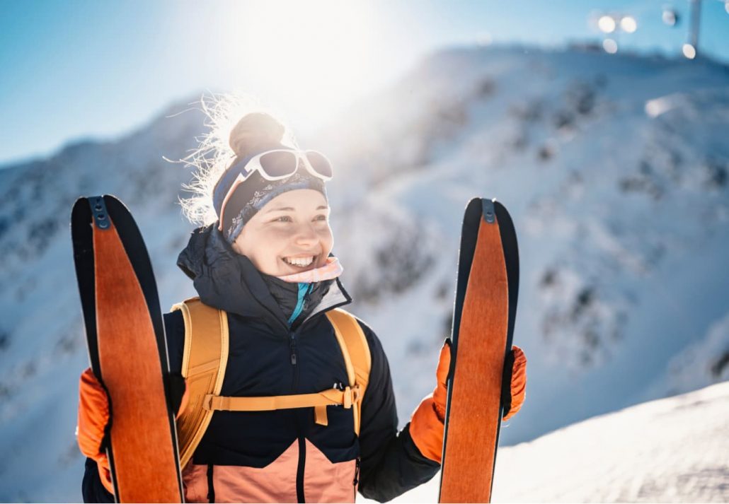 Young woman happily skiing.