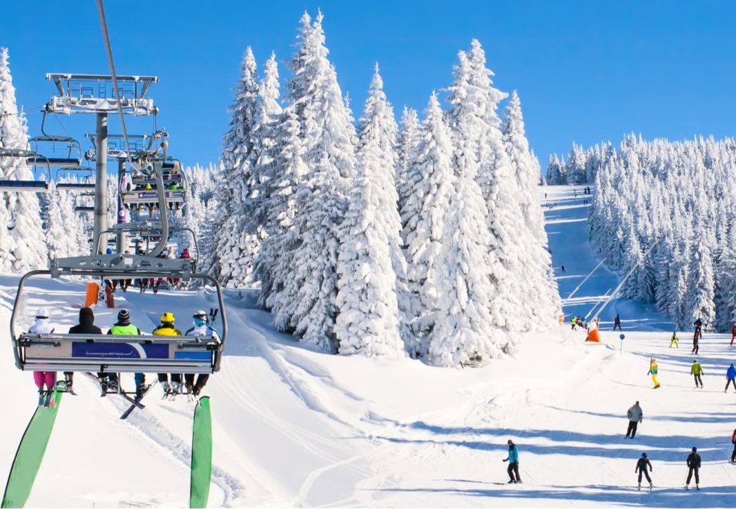 People in a charlift in a ski resort.