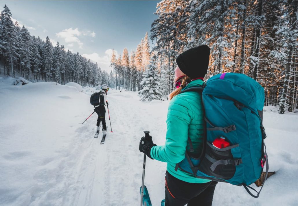 Two people happily skiing.