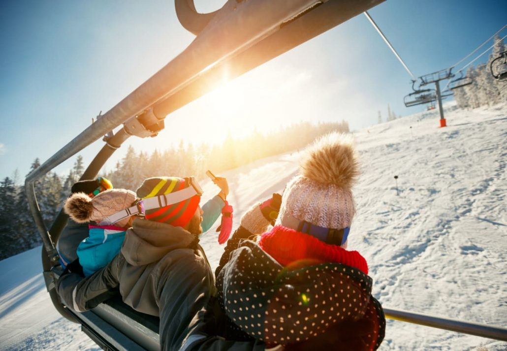 Friends driving in a cable car at a ski center