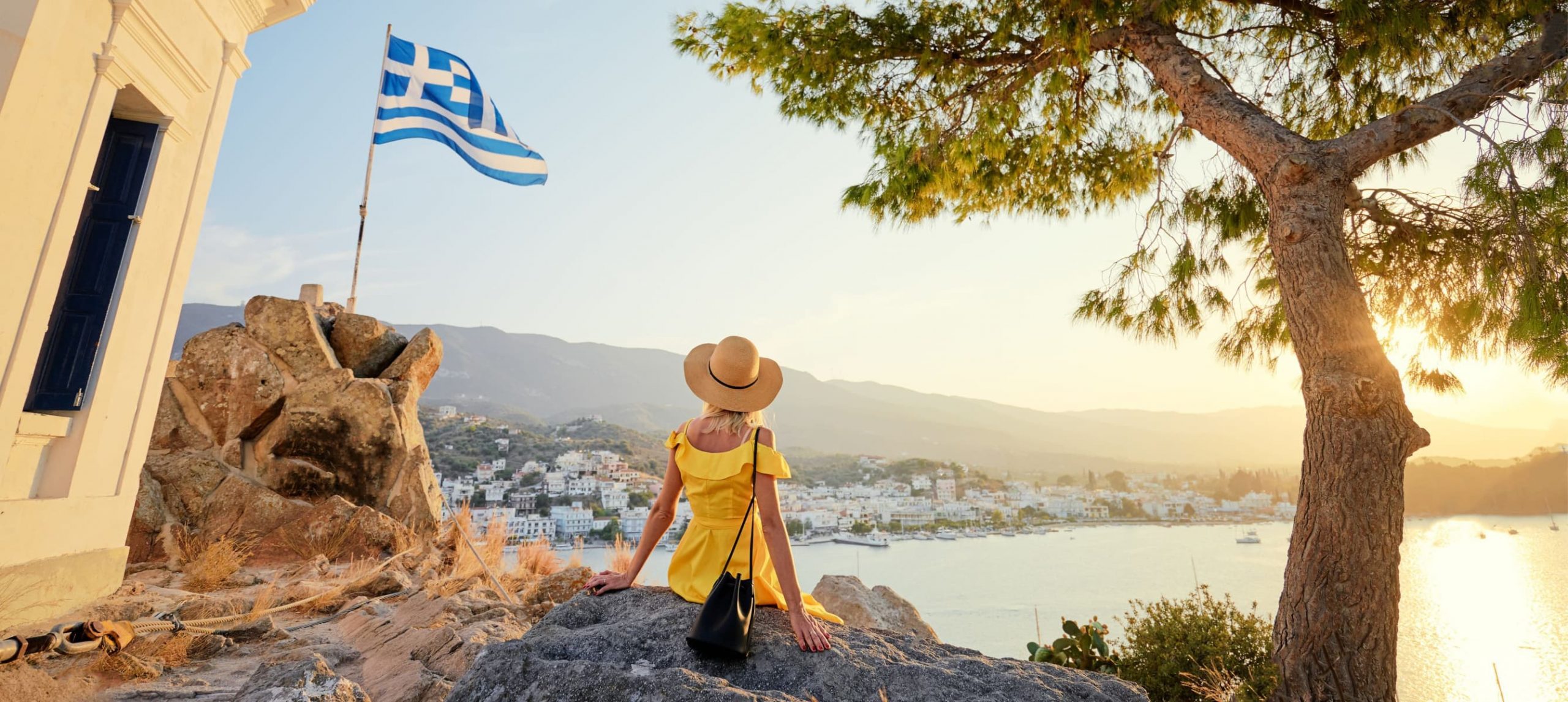 A woman looking at the Greek sea in the distance