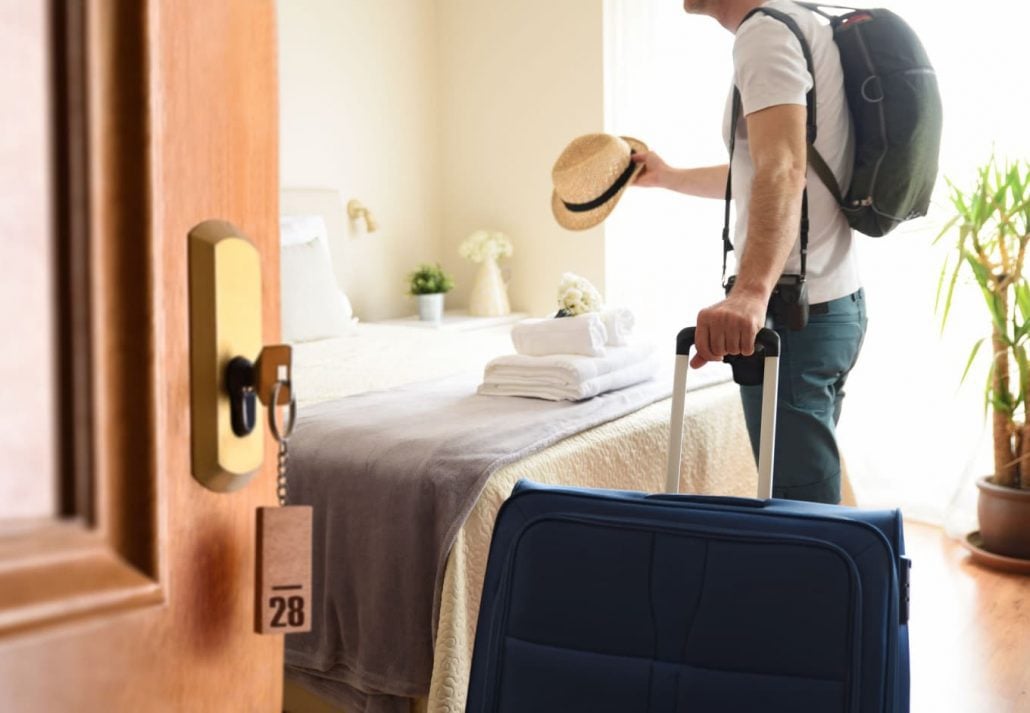 A man entering his hotel room