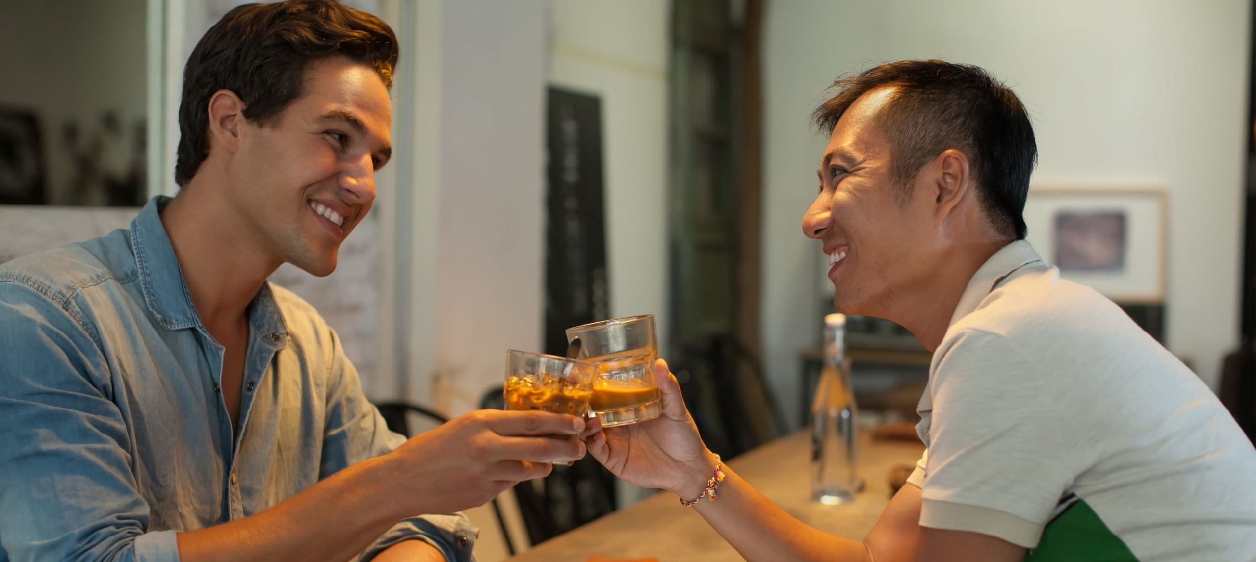 Gay couple having drinks.