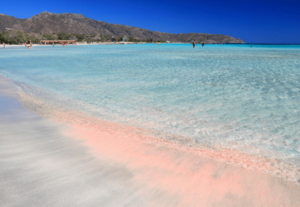 Pink ombre Elafonisi beach Crete with hills in the background