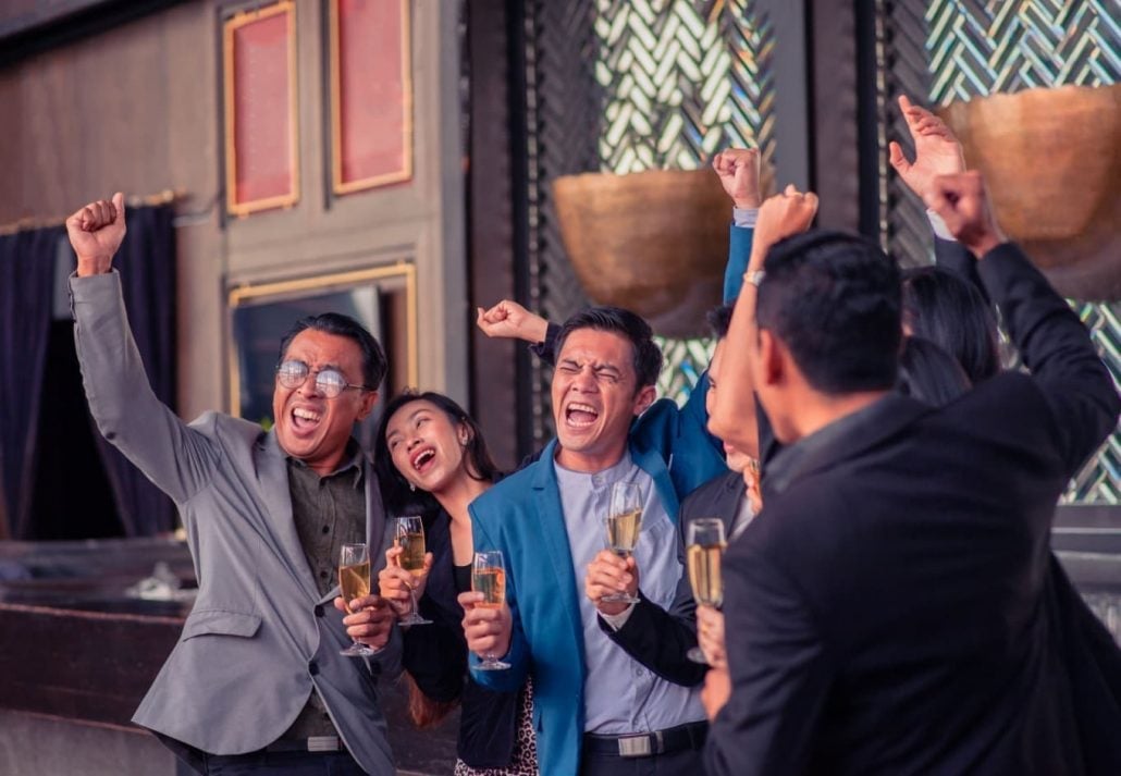 People celebrating with a glass of drink