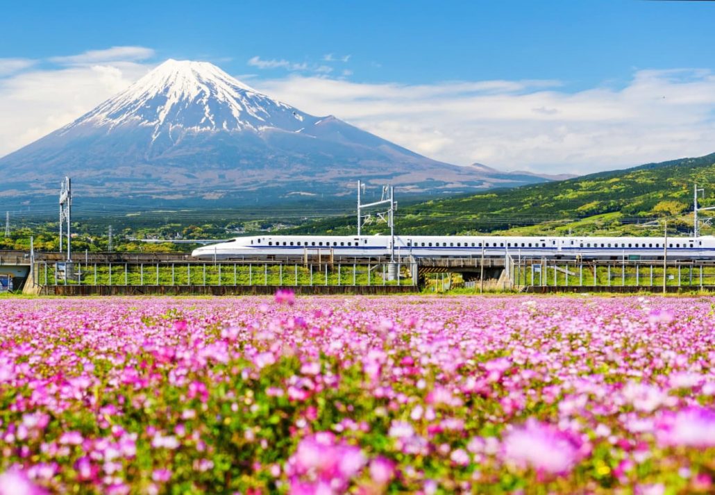 A bullet train with Mount Fuji in the distance