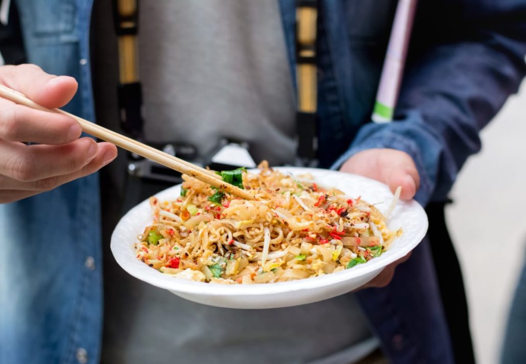 A tourist eating Pad Thai