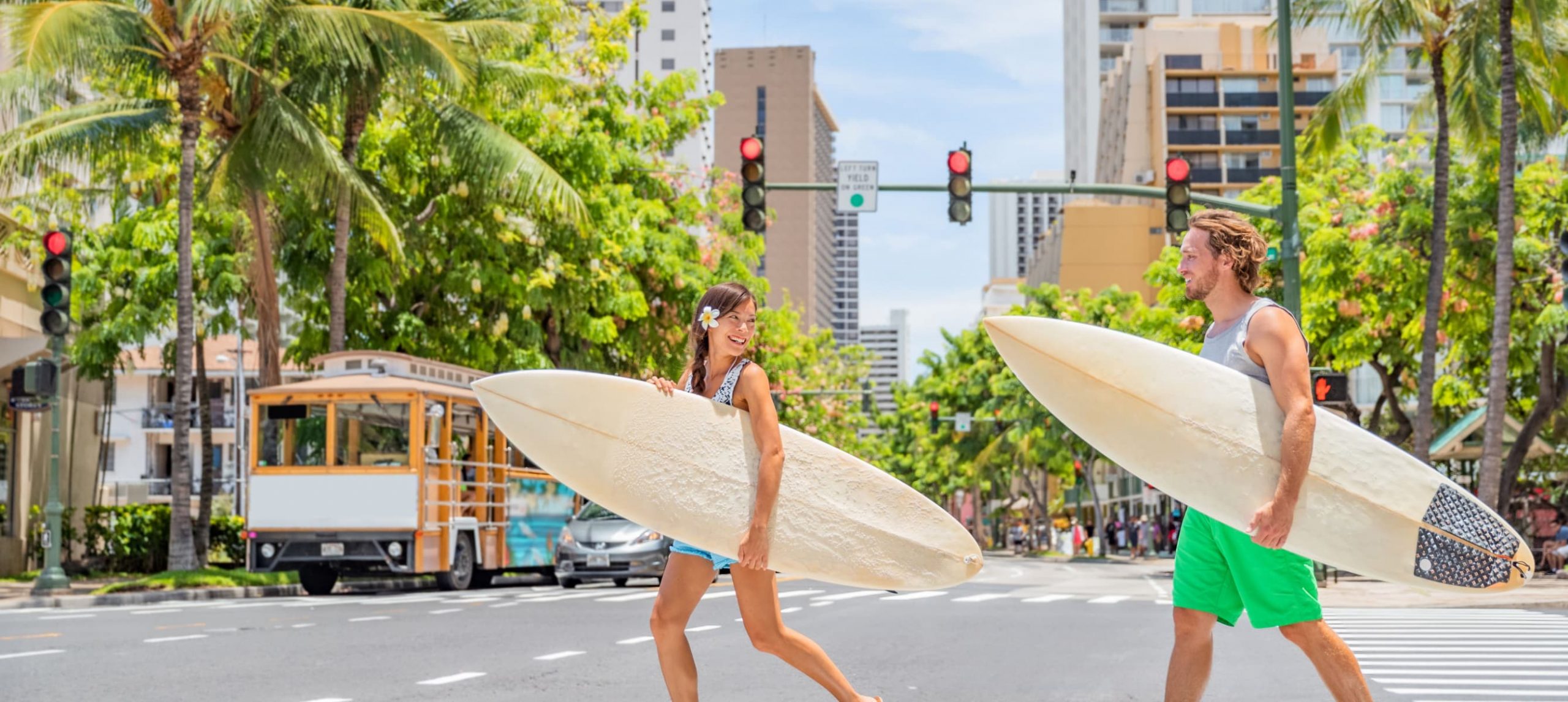 People walking with surfboards in Honolulu