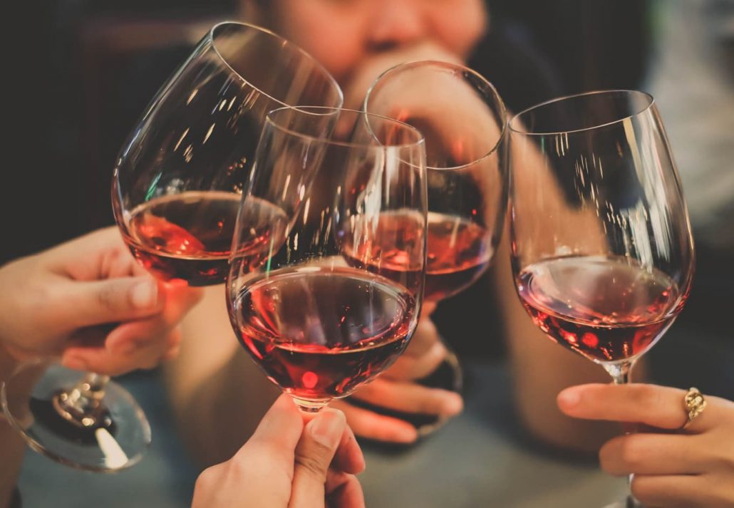 people holding wine glasses