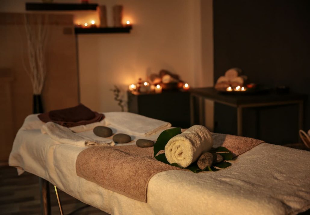 a massage table with hot stones at a spa