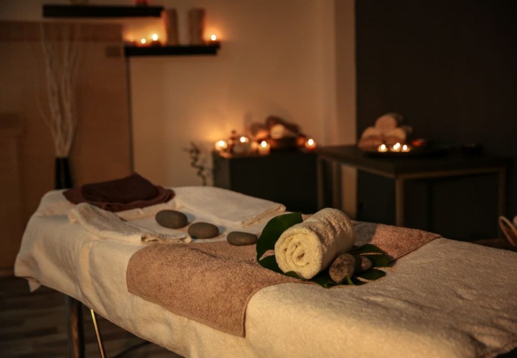 Spas In Honolulu - a massage table with hot stones at a spa