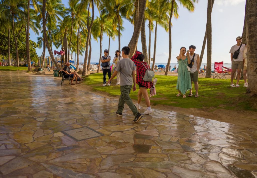 tourists walking in rainy Honolulu