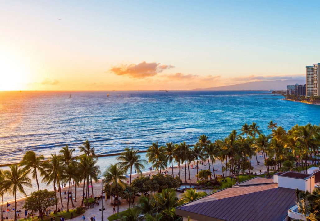 a beach in Honolulu during sunset