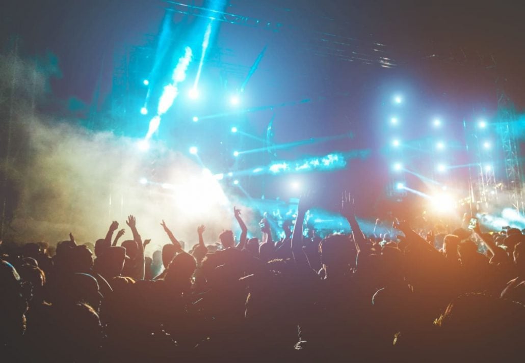 A young crowd during a fun music festival at nighttime.