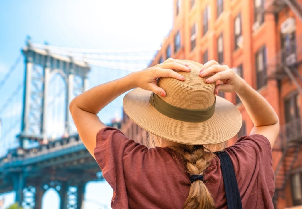 A young woman gazing at New York's Brooklyn Bridge.