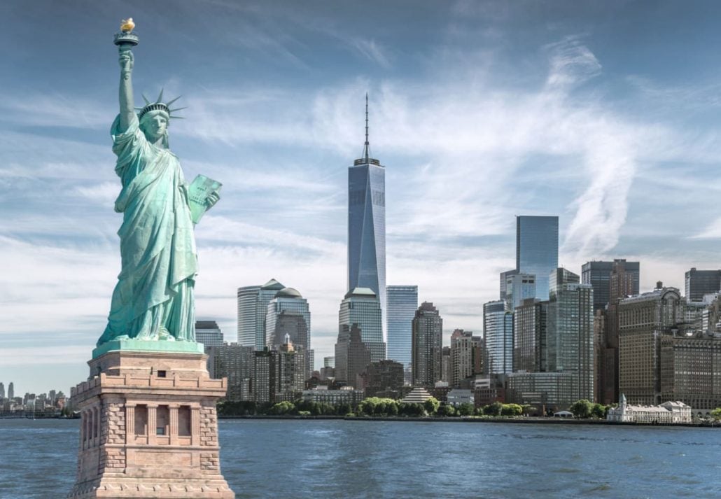 The Statue of Liberty with the New York City skyline on the background.