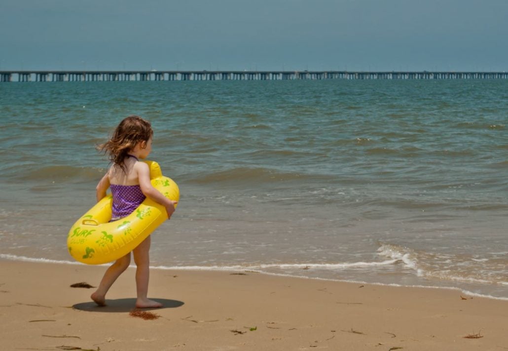 A little girl at the Chesapeake Bay Beach, Virginia Beach, Virginia.