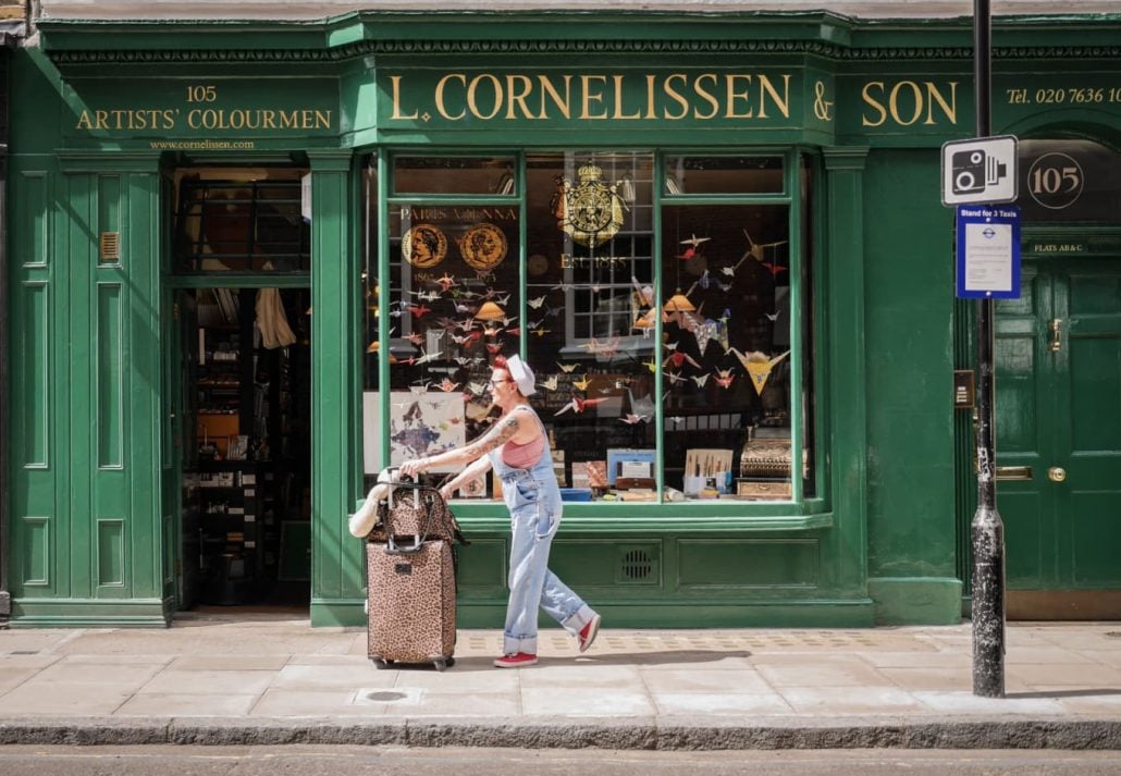 Best Neighborhoods in London - Woman traveler walking in front of a store in Bloomsbury, London, UK.