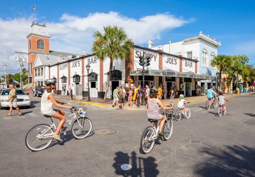A group of people biking in Key West's Duval Street, in Florida.