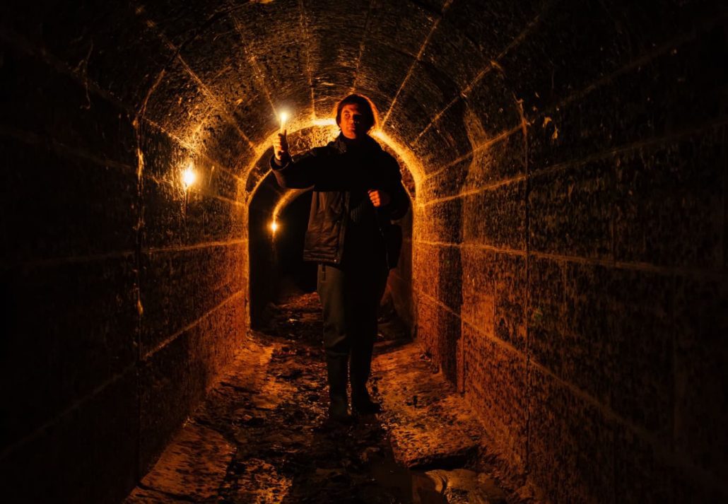 A creepy man in an underground vault.