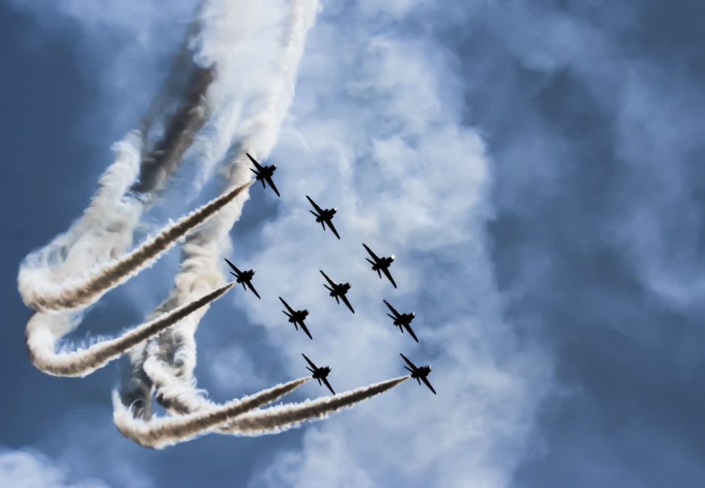 a couple of planes in the sky during the airshow event