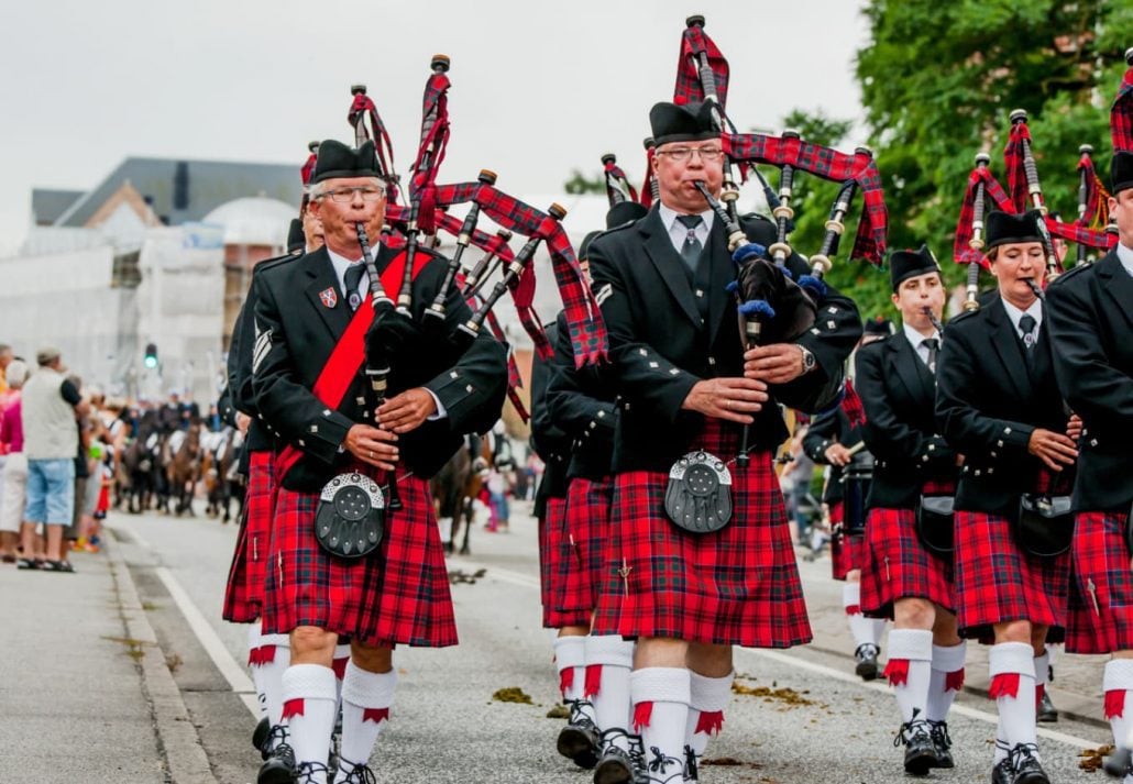 Men dressed in typical attire while playing pipes during the Inverness Highland Games, in Inverness, Scotland.