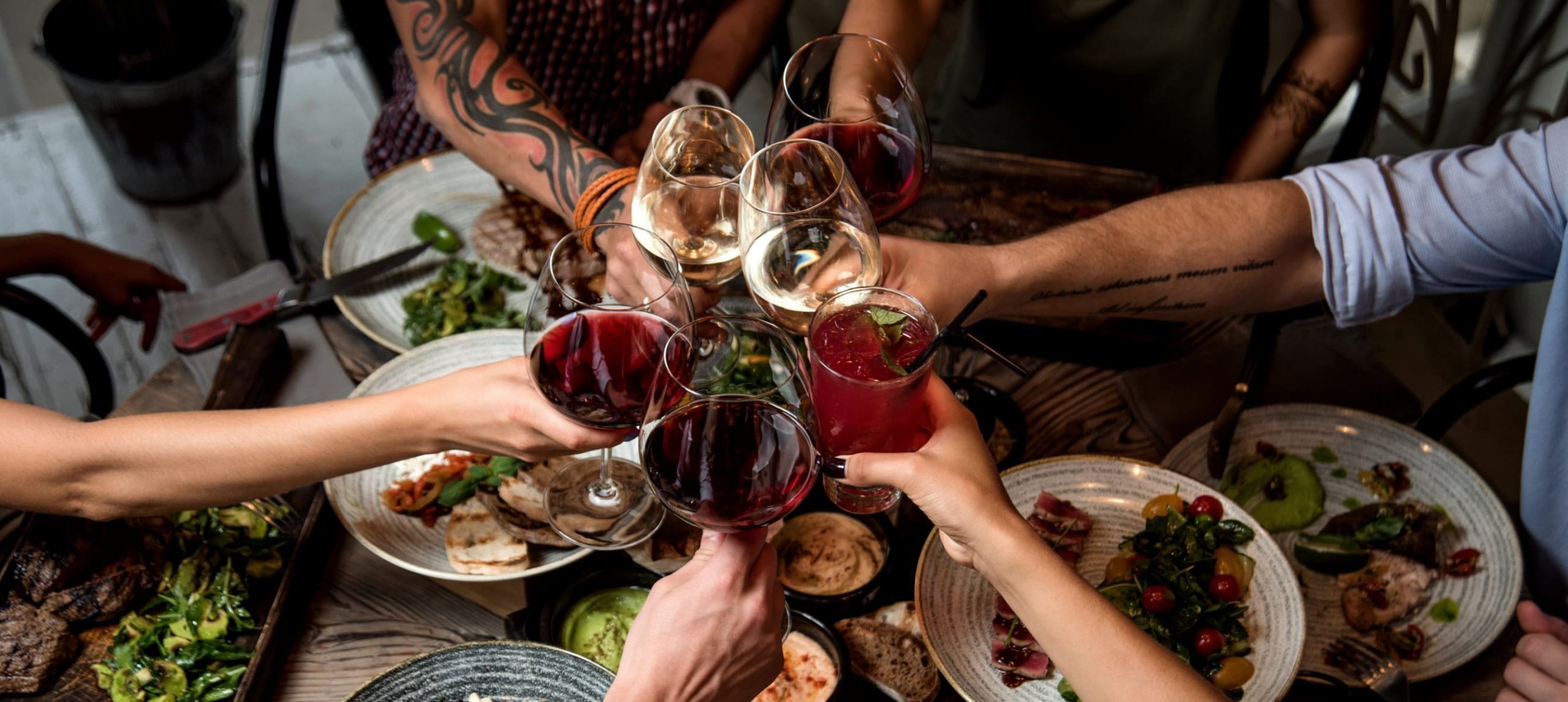 people clinking glasses at a restaurant table