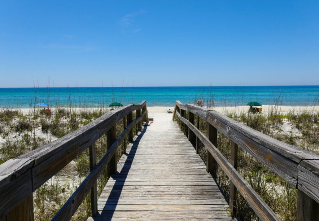 best-places-in-florida-henderson-beach-state-park | CuddlyNest Travel Blog A beautiful view of a wooden path going to Henderson Beach State Park Destin, Florida, USA.