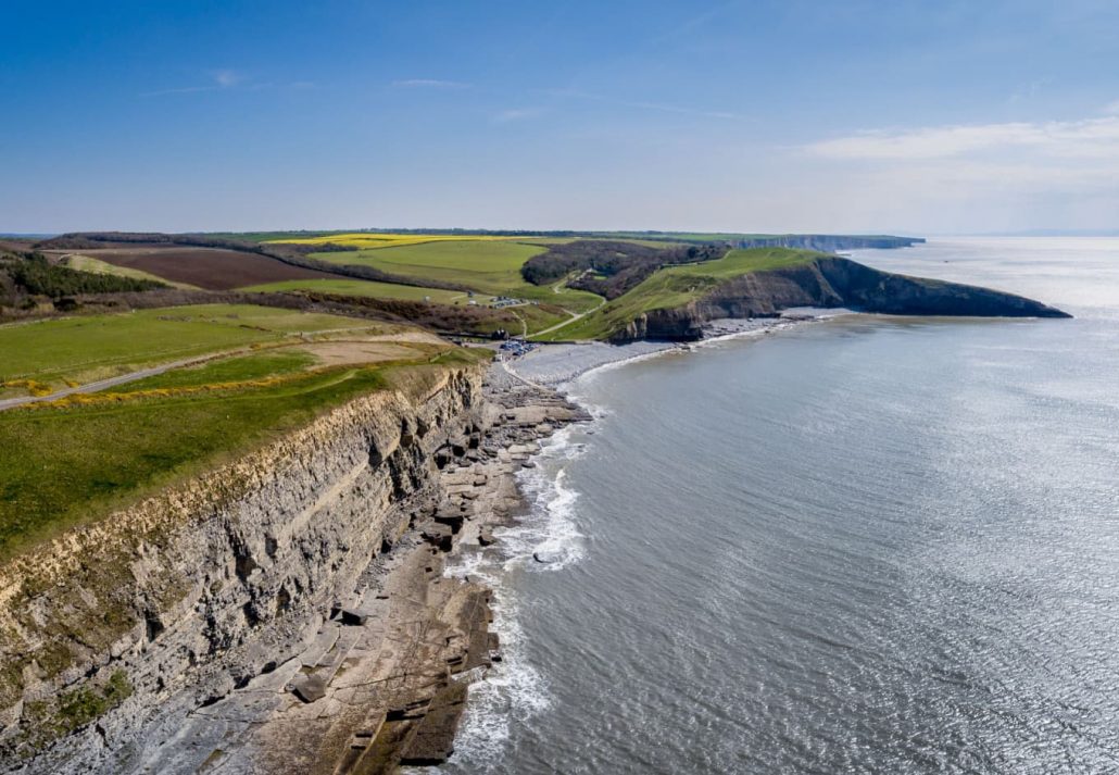 An aerial view of The beach and cliffs at Dunraven Bay at Southerndown on the south coast of Wales, UK.