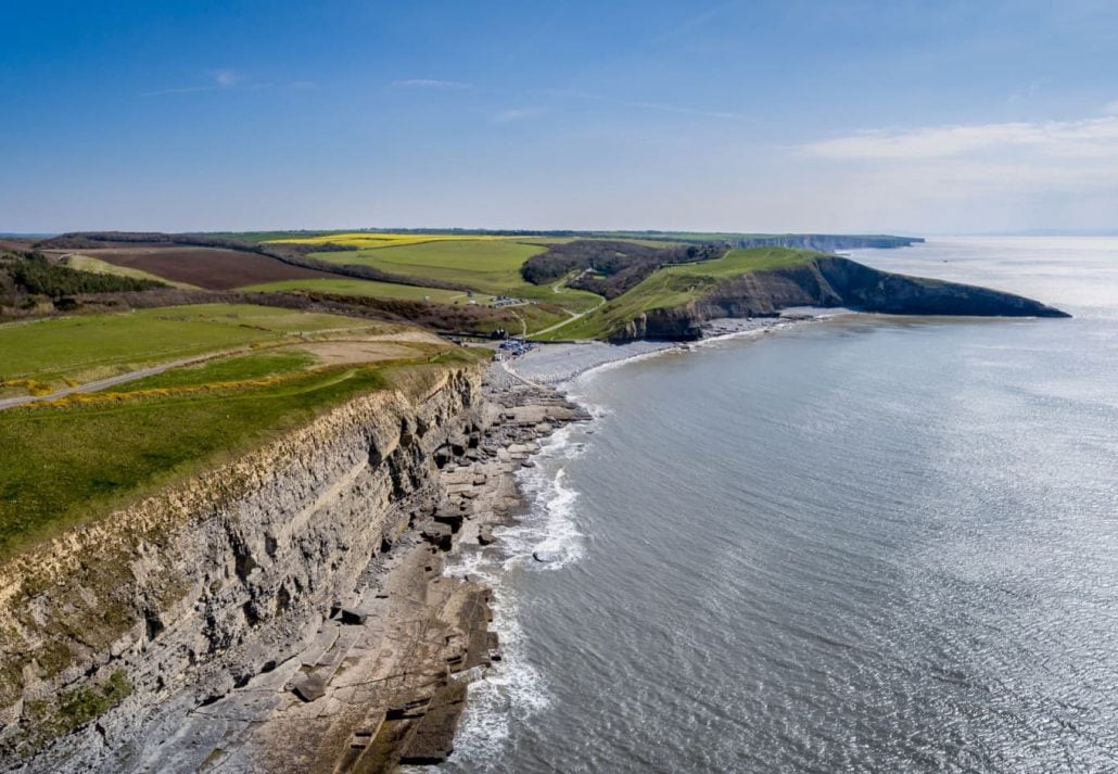 An aerial view of The beach and cliffs at Dunraven Bay at Southerndown on the south coast of Wales, UK.