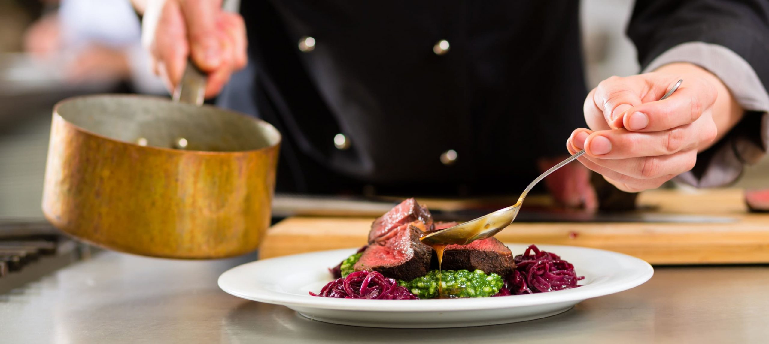 a chef preparing food at a fine dining restaurant