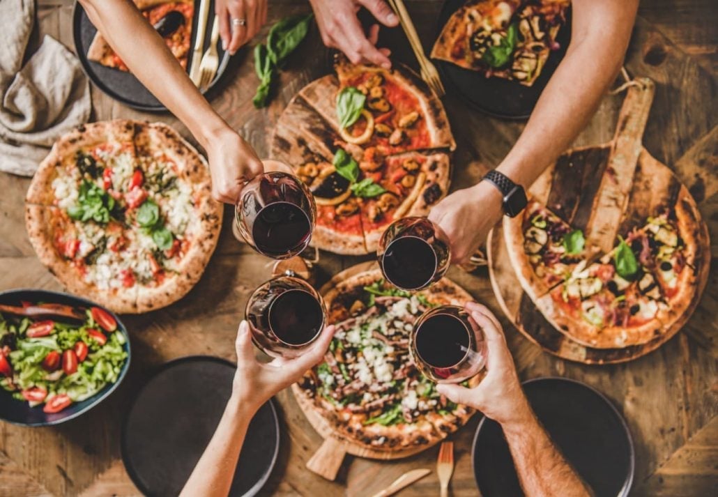 a couple of pizzas on plates at a restaurant