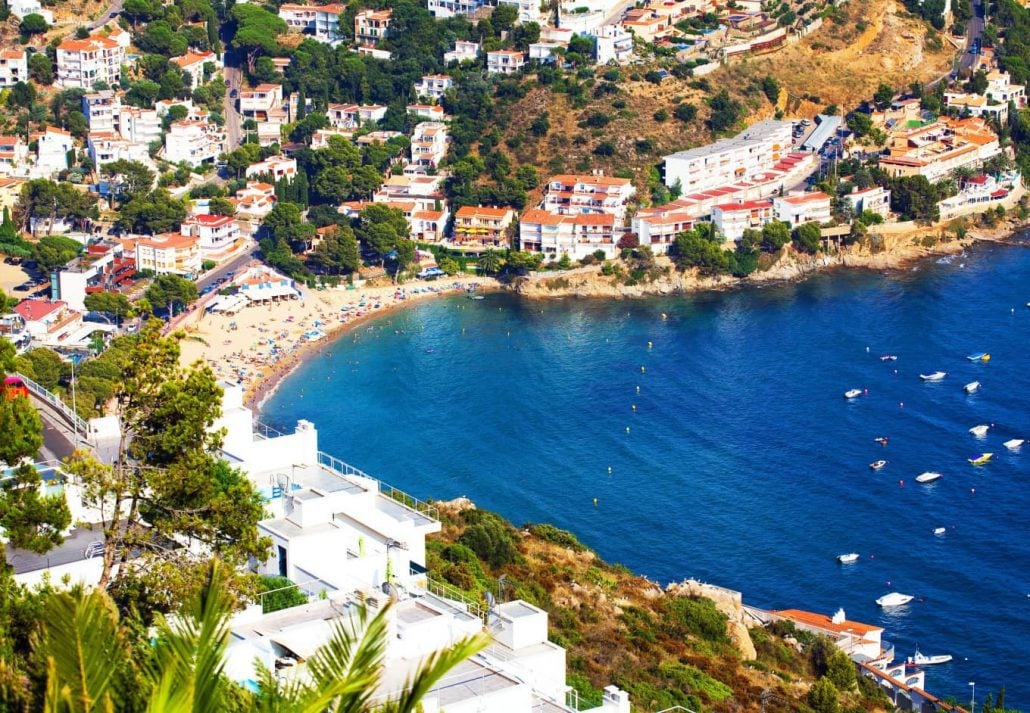 Coast with the people on the beach on a sunny day in Costa Brava, Catalonia, Spain.