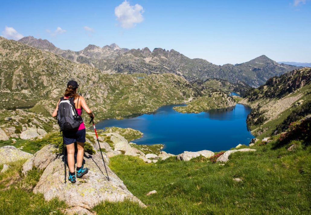 Young girl summit to Ratera Peak in Aiguestortes and Sant Maurici National Park, Pyrenees, Spain.