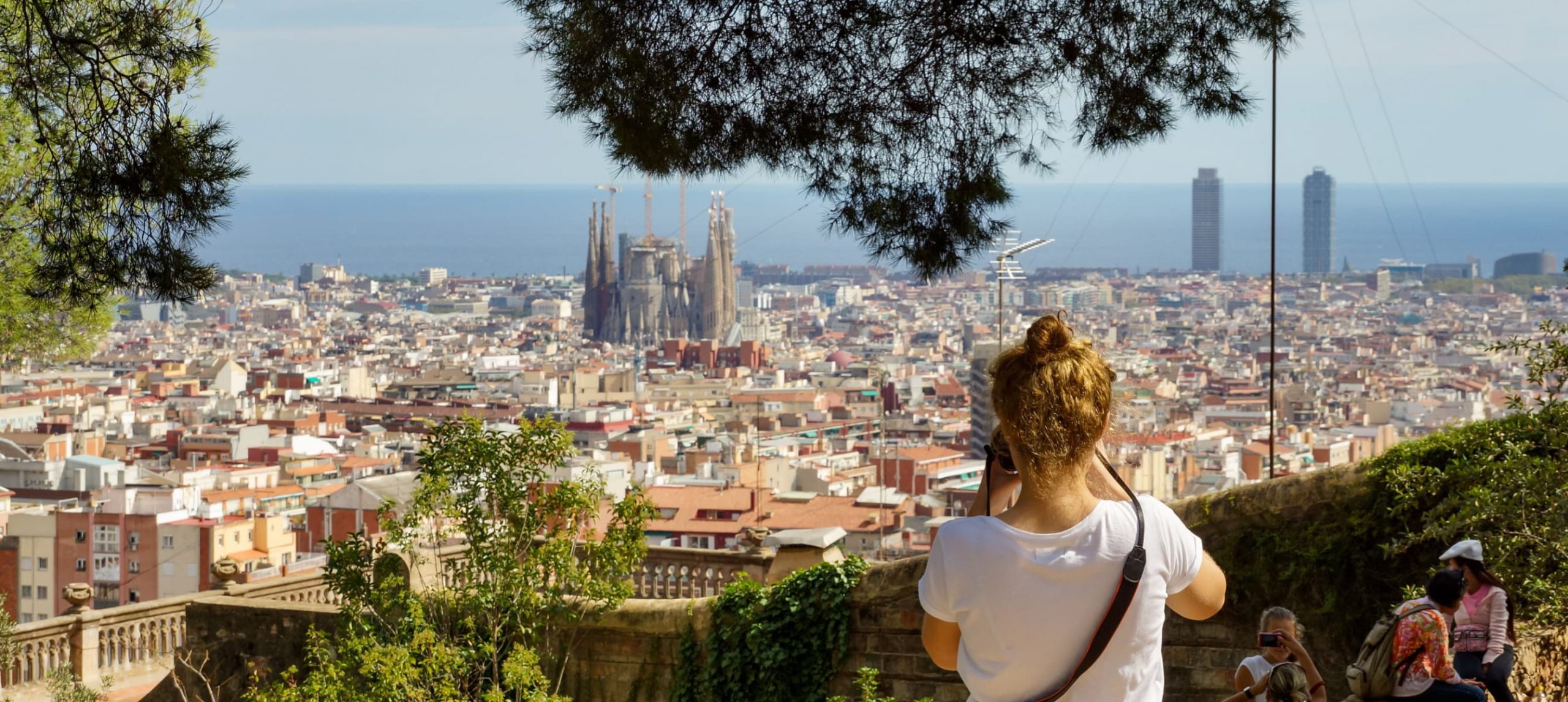 Woman traveler taking a picture of La Sagrada Familia in Barcelona, Spain.