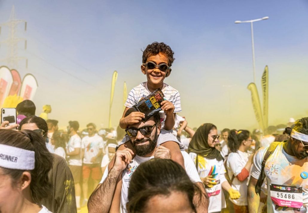 Boulevard Riyadh City - a father and son at a colorful event in Boulevard