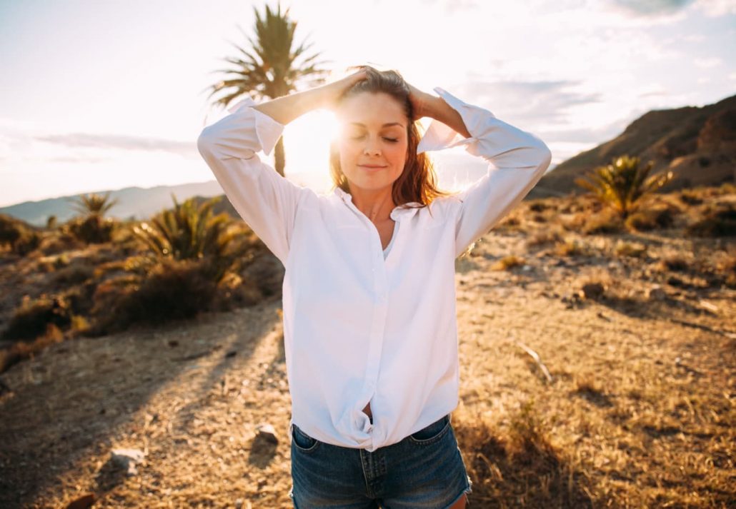 a woman posing in a desert area