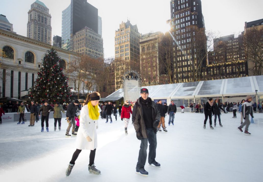 a man and a woman ice skating in Winter Village